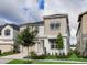 Charming two-story home features a combination of stucco and siding, complemented by green grass and trees at 1810 Caribbean View Ter, Kissimmee, FL 34747