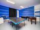 Bright game room with a foosball table, ping pong table, and modern bar-style seating for entertainment at 1810 Caribbean View Ter, Kissimmee, FL 34747