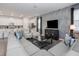 Open-concept living room with modern decor, adjacent to a bright kitchen with stainless steel appliances at 1810 Caribbean View Ter, Kissimmee, FL 34747