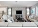 Sophisticated living room features a large sectional sofa, modern entertainment center, and stylish decor at 1810 Caribbean View Ter, Kissimmee, FL 34747