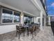 Spacious covered patio with an outdoor dining table and chairs, perfect for entertaining at 1810 Caribbean View Ter, Kissimmee, FL 34747
