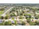 Aerial view of a residential neighborhood with tree-lined streets and well-maintained homes and landscaping at 1822 Ashton E Dr, St Cloud, FL 34771
