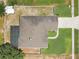 Overhead aerial view of the home's roof, backyard, and driveway surrounded by lawn at 1822 Ashton E Dr, St Cloud, FL 34771