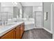 Bathroom featuring double sinks, a soaking tub, and a glass-enclosed shower at 1822 Ashton E Dr, St Cloud, FL 34771