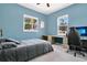 A comfortable bedroom with a desk for a workspace near the window at 1822 Ashton E Dr, St Cloud, FL 34771