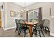 Classic dining room features a wooden table, seating for six, with a chandelier and large window adding character at 1822 Ashton E Dr, St Cloud, FL 34771