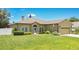 Charming single-story home featuring manicured lawn, arched windows, and an attached two-car garage at 1822 Ashton E Dr, St Cloud, FL 34771