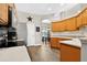 Well-equipped kitchen with wooden cabinets, stainless steel appliances, and an inviting view into the dining room at 1822 Ashton E Dr, St Cloud, FL 34771