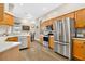 Modern kitchen with stainless steel appliances, wooden cabinets, and ample counter space, making it a chef's dream at 1822 Ashton E Dr, St Cloud, FL 34771