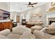 Spacious living room with fireplace, wood floors, and lots of comfy seating perfect for entertaining friends and Gathering at 1822 Ashton E Dr, St Cloud, FL 34771
