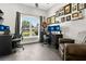Office space with a large window, multiple monitors, and stylish decor at 1822 Ashton E Dr, St Cloud, FL 34771