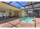 Heated pool featuring a screened enclosure and outdoor seating area at 1822 Ashton E Dr, St Cloud, FL 34771