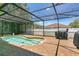 A kidney-shaped pool with a screened enclosure and brick pavers at 1822 Ashton E Dr, St Cloud, FL 34771
