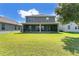 A sprawling backyard and covered patio offer space for outdoor living and entertainment at 1856 Castleton Dr, St Cloud, FL 34771