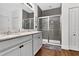 Beautiful bathroom featuring double vanity, granite countertops, and large shower with glass door and gray subway tile at 1856 Castleton Dr, St Cloud, FL 34771