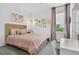 Cozy bedroom with natural light, wood-frame bed, stylish decor, and a comfortable atmosphere for rest and relaxation at 1856 Castleton Dr, St Cloud, FL 34771