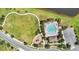 Aerial view of the community pool, playground and green space, ideal for Gathering recreation and relaxation at 1856 Castleton Dr, St Cloud, FL 34771