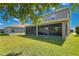 Exterior view of a home showcasing a spacious screened patio that offers seamless indoor-outdoor living and entertainment at 1856 Castleton Dr, St Cloud, FL 34771