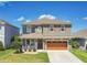 Charming two-story home with a well-manicured lawn, inviting front porch, and a convenient two-car garage at 1856 Castleton Dr, St Cloud, FL 34771