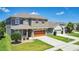 Beautiful two-story home featuring a well-manicured lawn, a two-car garage, and charming curb appeal at 1856 Castleton Dr, St Cloud, FL 34771