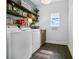 Efficient laundry room with washer, dryer, and ample shelving, designed for convenience and organization at 1856 Castleton Dr, St Cloud, FL 34771
