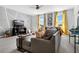 Spacious living room with large comfortable seating, modern decor, and ample natural light from the windows at 1856 Castleton Dr, St Cloud, FL 34771
