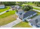 Aerial view of a home with a paved driveway and well-maintained landscaping at 1913 Manatee Ct, Kissimmee, FL 34759