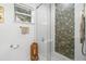Modern bathroom featuring a glass-enclosed shower with decorative tile and updated fixtures at 1913 Manatee Ct, Kissimmee, FL 34759