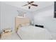 Bright bedroom featuring a large bed and a ceiling fan for added comfort at 1913 Manatee Ct, Kissimmee, FL 34759