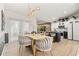 Chic dining room featuring a gold-accented table, stylish lighting, and modern kitchen in the background at 1913 Manatee Ct, Kissimmee, FL 34759