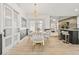 Elegant dining area with modern lighting, stylish chairs, and an open view to the kitchen at 1913 Manatee Ct, Kissimmee, FL 34759