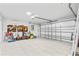 Spacious garage with ample storage space, work area, and a durable tile floor at 1913 Manatee Ct, Kissimmee, FL 34759