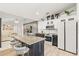 Modern kitchen features a granite island, stainless steel appliances, and sleek cabinetry at 1913 Manatee Ct, Kissimmee, FL 34759