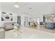 Open-concept living room with marble floors, modern lighting, and stylish furnishings at 1913 Manatee Ct, Kissimmee, FL 34759