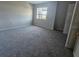 Light-filled bedroom with carpet, large window, and a closet at 1920 Conway Rd # 4, Orlando, FL 32812