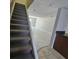 Carpeted stairway with gray paint and tile, leading to the upper level of the home at 1920 Conway Rd # 4, Orlando, FL 32812