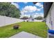 Large fenced backyard featuring green grass, storage shed, and fire pit at 2 S Lavon Ave, Kissimmee, FL 34741
