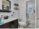 This is a renovated bathroom featuring a modern vanity, shiplap accent wall, and updated fixtures at 2 S Lavon Ave, Kissimmee, FL 34741