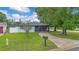 Well-maintained front yard with a long driveway and mature trees at 2 S Lavon Ave, Kissimmee, FL 34741