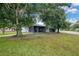 Charming single-story home with large trees, a screened porch and well-manicured lawn on a corner lot at 2 S Lavon Ave, Kissimmee, FL 34741