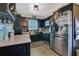 This kitchen has stainless steel appliances, granite countertops and black cabinets offering both style and functionality at 2 S Lavon Ave, Kissimmee, FL 34741