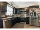 Modern kitchen features stainless steel appliances and black cabinets, combining style with practicality at 2 S Lavon Ave, Kissimmee, FL 34741