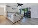 Bright living room boasts a neutral color palette, ceiling fan, and an oversized window for great natural light at 2 S Lavon Ave, Kissimmee, FL 34741