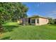 Spacious backyard showcases a screened patio, offering an ideal blend of indoor and outdoor living at 214 Verona Dr, Kissimmee, FL 34759