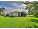 Lush backyard with a screened-in lanai, providing a peaceful outdoor space with plenty of greenery at 214 Verona Dr, Kissimmee, FL 34759