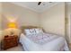 Inviting bedroom featuring a cozy bed, a nightstand with a lamp, and neutral-colored walls at 214 Verona Dr, Kissimmee, FL 34759