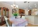 Cozy dining room adjacent to the kitchen featuring a chandelier and a glass curio cabinet at 214 Verona Dr, Kissimmee, FL 34759