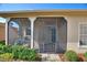 The home has a screened-in front porch entry with brick pavers and an ornamental metal door at 214 Verona Dr, Kissimmee, FL 34759