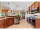 The kitchen has stainless steel appliances, wooden cabinetry, and a bar overlooking the dining area at 214 Verona Dr, Kissimmee, FL 34759
