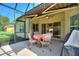 Enclosed patio area showcases a comfortable seating arrangement, perfect for relaxing and enjoying the backyard view at 214 Verona Dr, Kissimmee, FL 34759